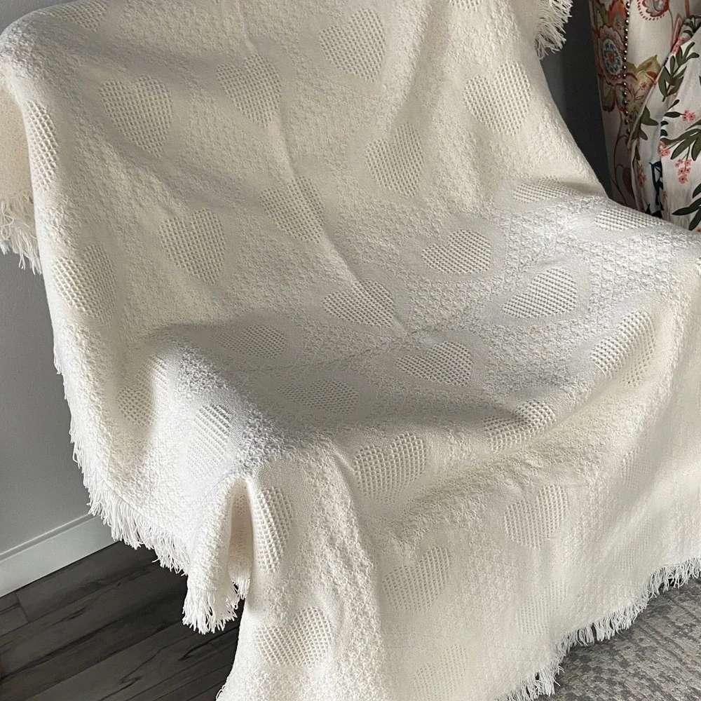 Beautiful white blanket with subtle heart detail.
